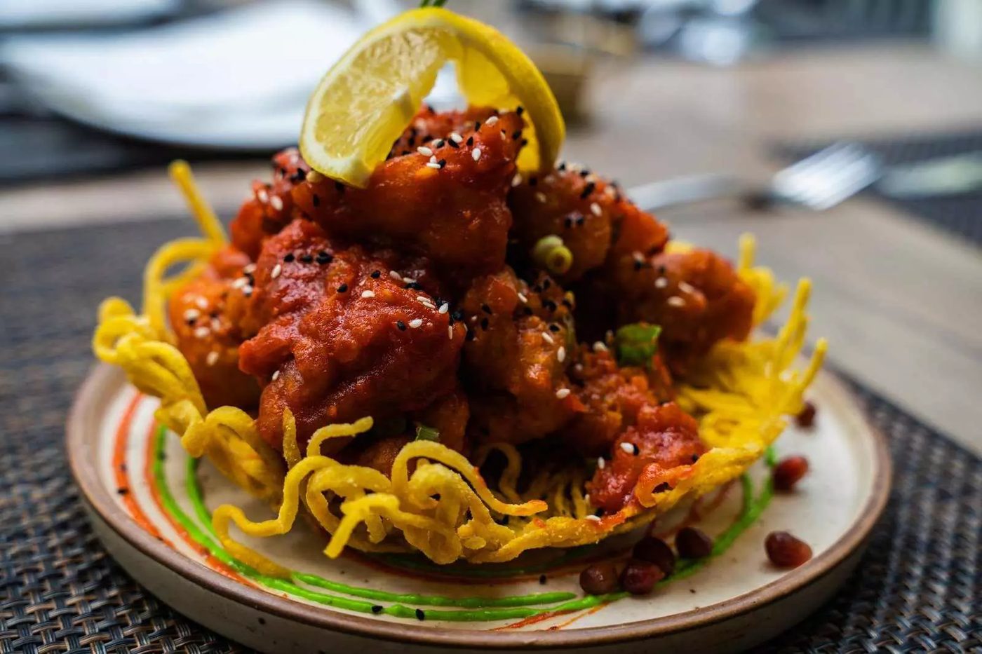 Chilli chicken on a crispy noodle nest at Aafrien Indian Restaurant, Toronto