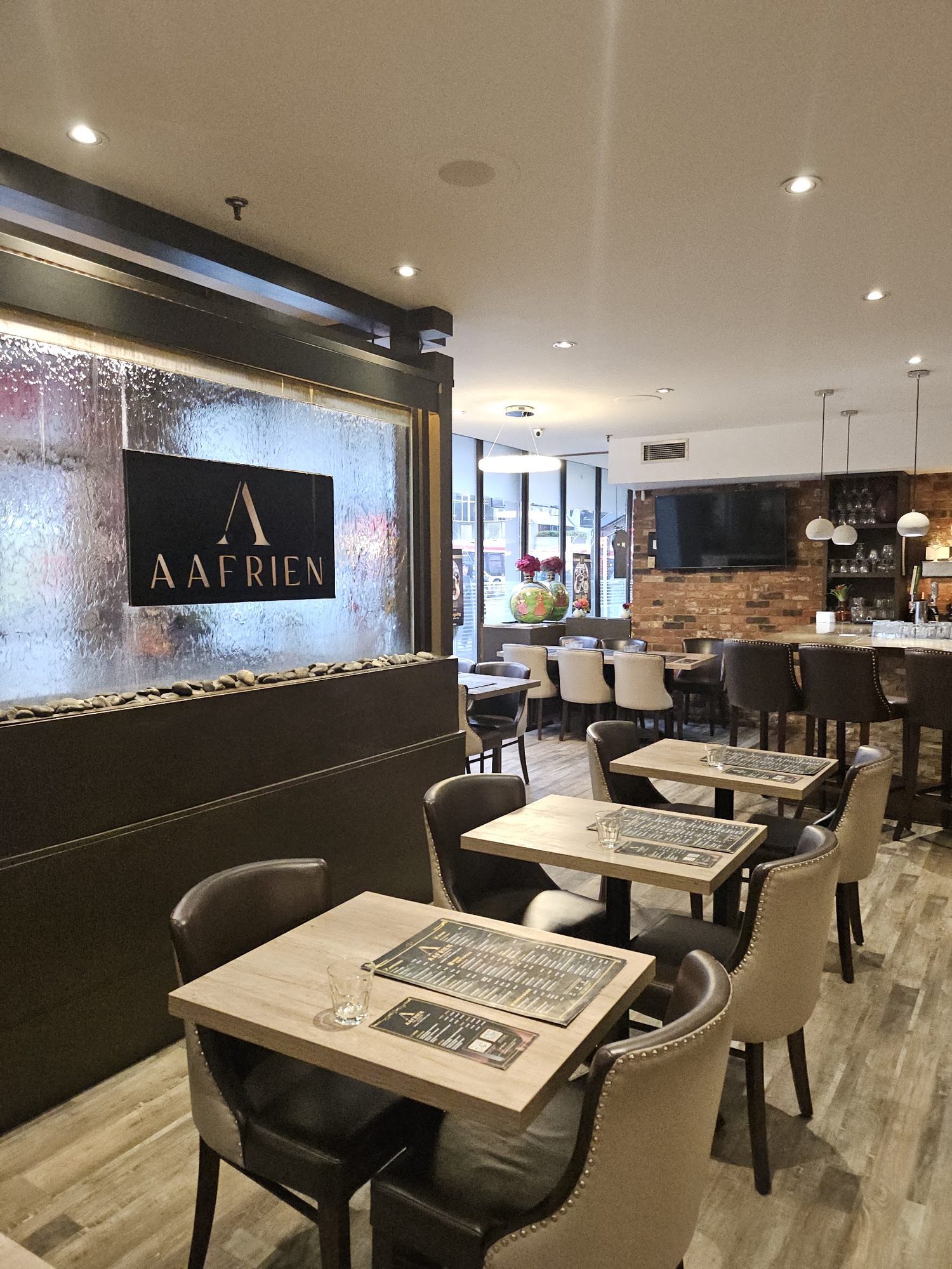 Inside Aafrien Indian Restaurant, the dining room with warm light and comfortable seating